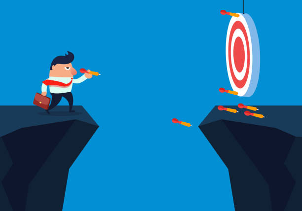 istock Businessman shooting darts across the cliff 1006615328