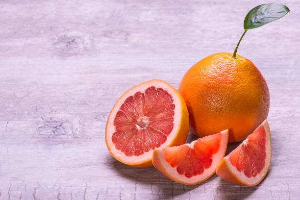 istock Grapefruit slices, juicy ripe isolated on a gray background. 1006615378