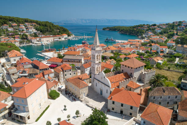 Aerial of the beautiful town Jesla with the famous St. Mary's Church, Island Hvar, Croatia Unique aerial of the beautiful croatian harbor town Jesla with its famous St. Mary’s Church. Located on the Island Hvar in the Adriatic Sea. Croatia. You can even see the Croatian Mainland in back. Converted from RAW. jelsa stock pictures, royalty-free photos & images