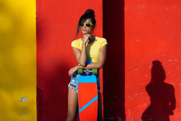istock Young woman with colorful skateboard 1006618804
