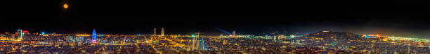 Amazing Barcelona's skyline at evening under a full moon Amazing Barcelona's skyline at evening under a full moon  Stitched Panorama barcelona skyline stock pictures, royalty-free photos & images