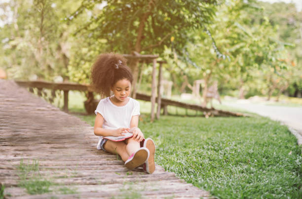 istock little girl reading book 1006619620