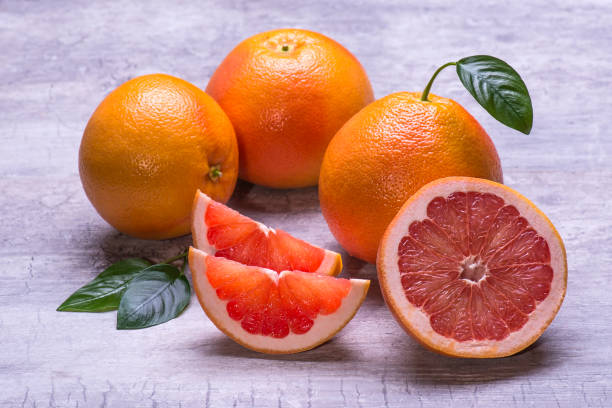 istock Grapefruit slices, juicy ripe isolated on a gray background 1006620180