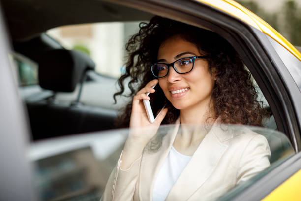 istock Businesswoman using smart phone while commuting to work by taxi 1006620446
