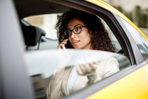 istock Businesswoman using smart phone while commuting to work by taxi 1006620538