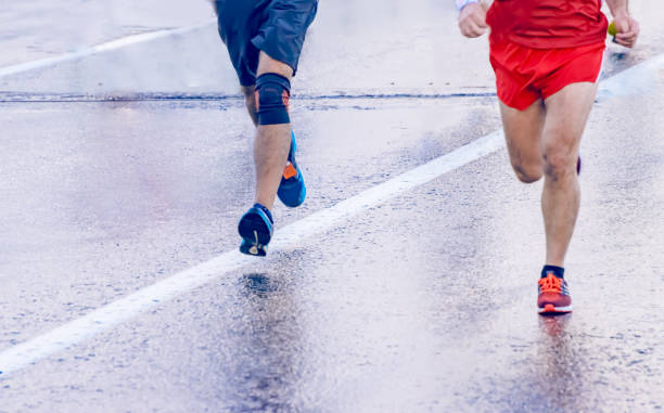 istock Legs of a group street marathon runners 1006620674