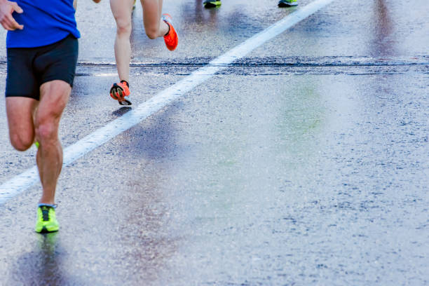 istock Legs of a group street marathon runners 1006620742