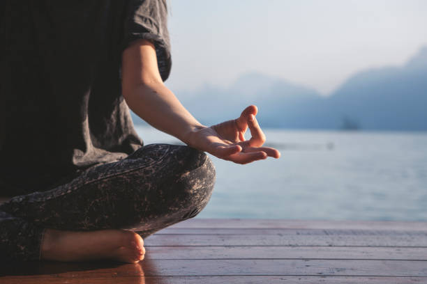istock Woman practicing yoga by a lake 1006624288