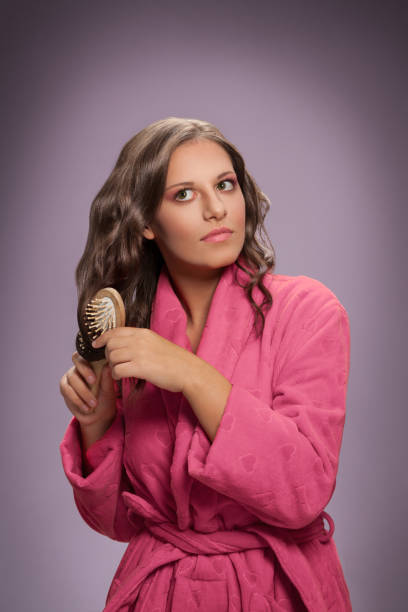 istock Woman with brush brushing hair 1006624416