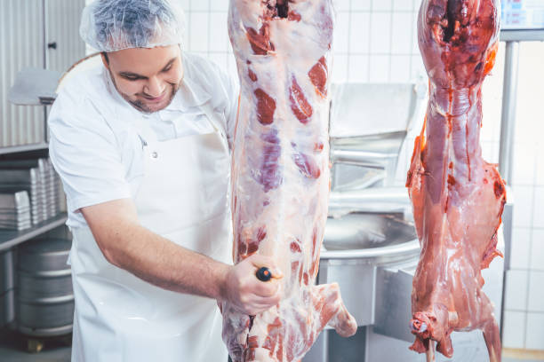 istock Butcher cutting to pieces meat from carcass 1006628728