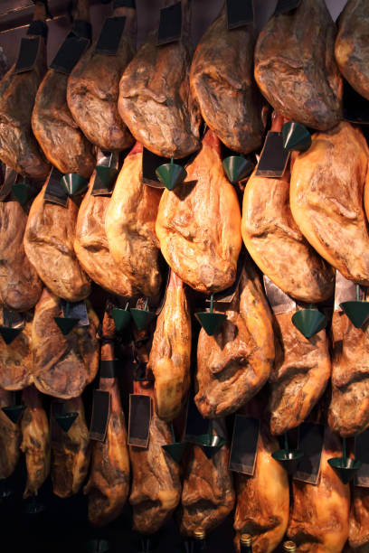 istock Jamon legs (Spanish ham) meat hanging in the shop. 1006629488