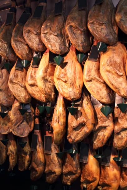 jamon legs (spanish ham) meat hanging in the shop. - serrano chilli pepper meat ham spain imagens e fotografias de stock