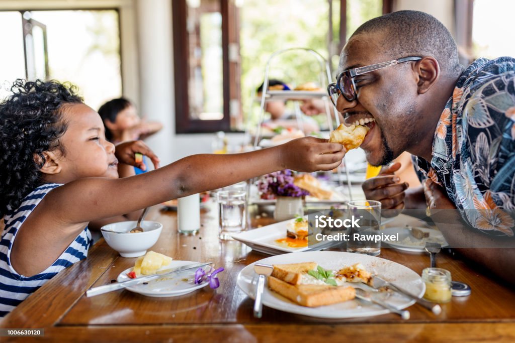 Guests having breakfast at hotel restaurant Family Stock Photo