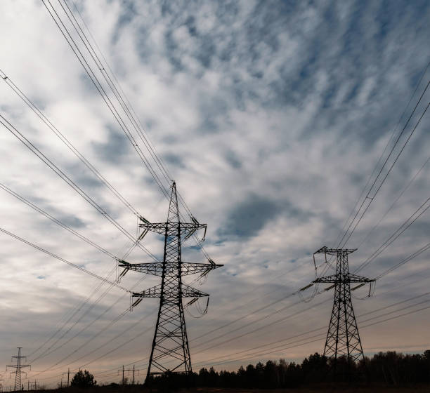 istock Silhouette High voltage electric tower on sunset time and sky on sunset time background. 1006632650