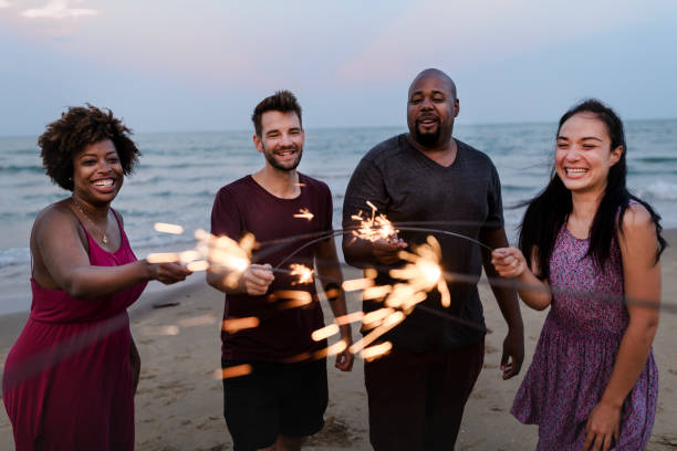 istock Friends celebrating with sparklers at the beach 1006633624
