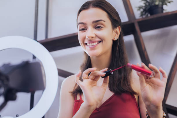 istock Beaming cheerful blogger telling about her favorites in cosmetics 1006637480