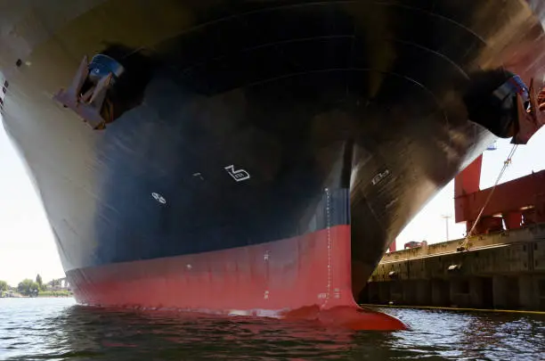 hull of a container ship with bulbous bow at the harbour of Hamburg, Germany