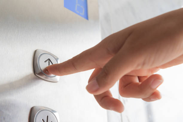 istock Close up waman hand press a up button of elevator inside the building for upper high level floor. 1006642214