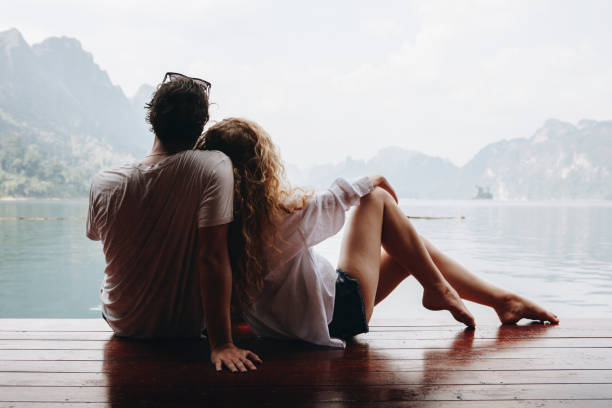 istock Woman relaxing in her boyfriends lap 1006642610