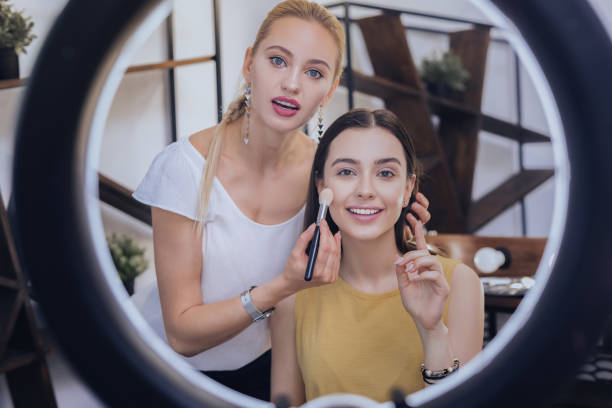 istock Blue-eyed makeup artist telling some makeup secrets her client 1006649040