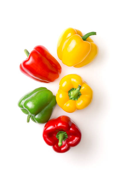 Variation of different color bell peppers on a white background. Colorful paprikas viewed from above isolated on white. Top view stock photo