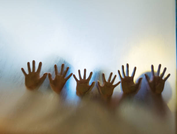 istock Human hands touching frosted glass 1006653378