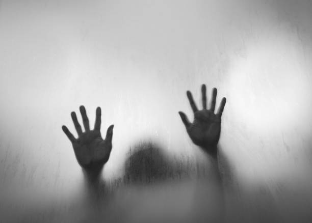 istock Child hands touching frosted glass 1006658290