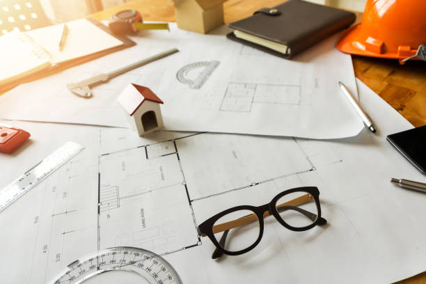 istock A eyeglasses with architect house model and etc on architect desk 1006658602