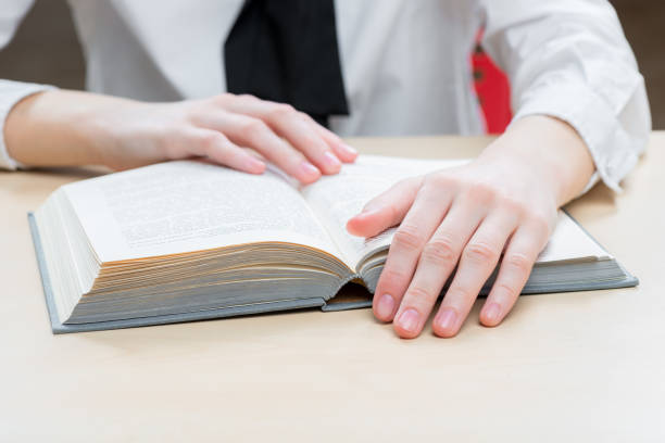 istock an interesting novel on a close-up table and women's hands 1006666152