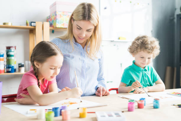 istock Art teacher and children in studio 1006670440