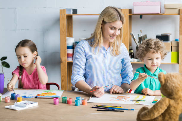 istock Mother drawing with children 1006670464