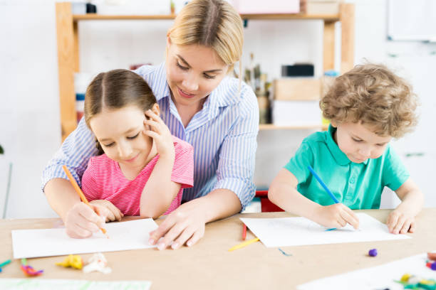 istock Children drawing with mother 1006670548
