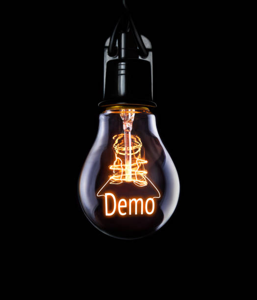 istock Hanging lightbulb with glowing Demo concept. 1006670958