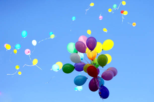 istock many multicolored balloons flying in the blue sky 1006671230