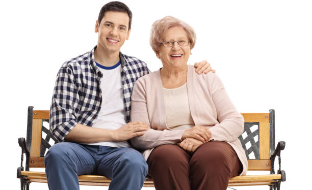 istock Young man and an elderly woman sitting on a bench 1006674036