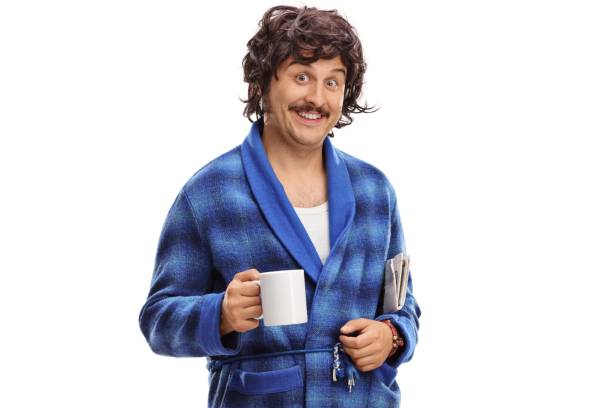 istock Guy in a bathrobe with a cup and a newspaper 1006674086