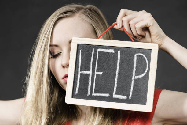 istock Suicidal woman holding help sign 1006674110