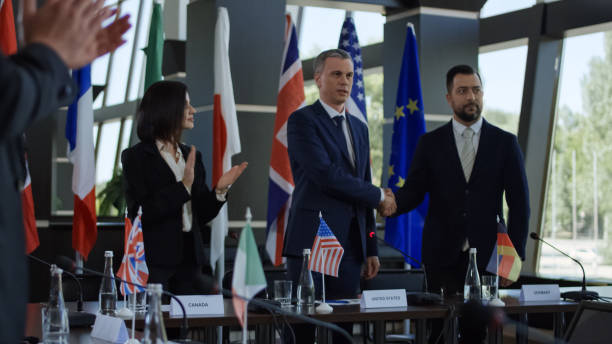 Politicians shaking hands in agreement on negotiation Official representatives shaking hands in agreement on international conference and posing for photo of social media global business handshake stock pictures, royalty-free photos & images