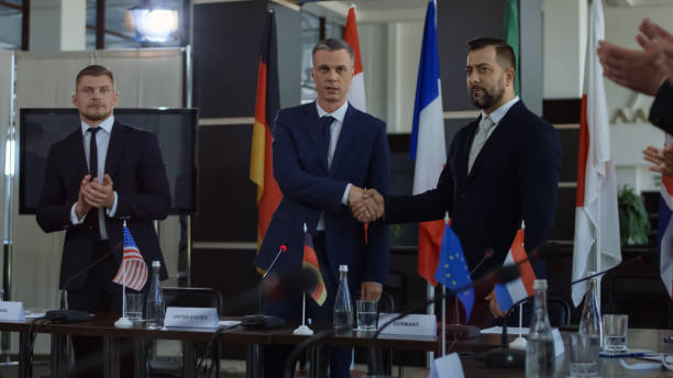 istock Politicians shaking hands in agreement on negotiation 1006677690