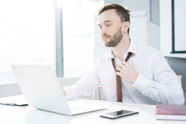 istock Businessman Loosening Tie 1006682812