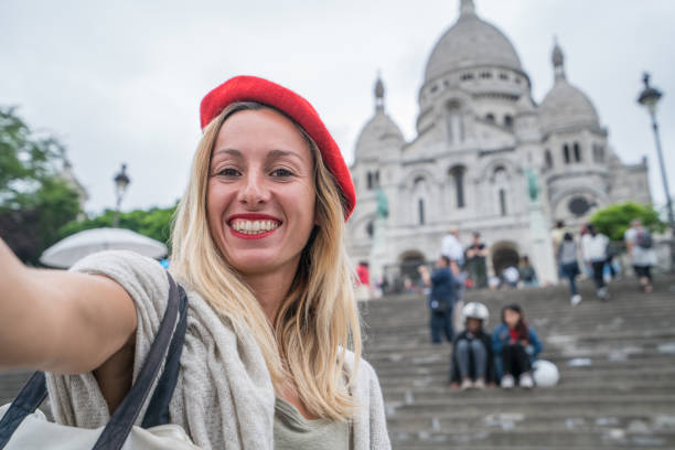 istock Young woman taking selfie in Paris using mobile phone, scare coeur 1006687300
