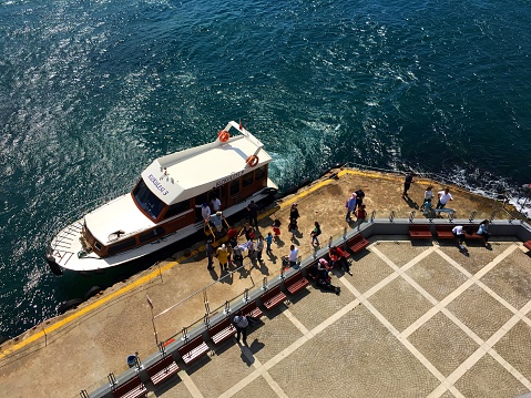 Maiden's Tower, Istanbul, Turkey - September 4, 2016: New visitors just arrived to the historical tower by boat.