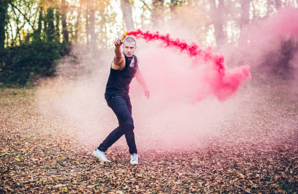 istock Male acrobatics with smoke fountain in forest 1006691338