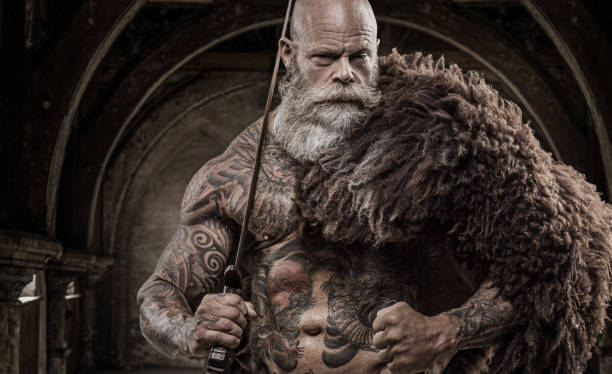 Bearded Tattooed Viking Warrior King In Front Of Warrior Hoard And  Background Stock Photo - Download Image Now - iStock