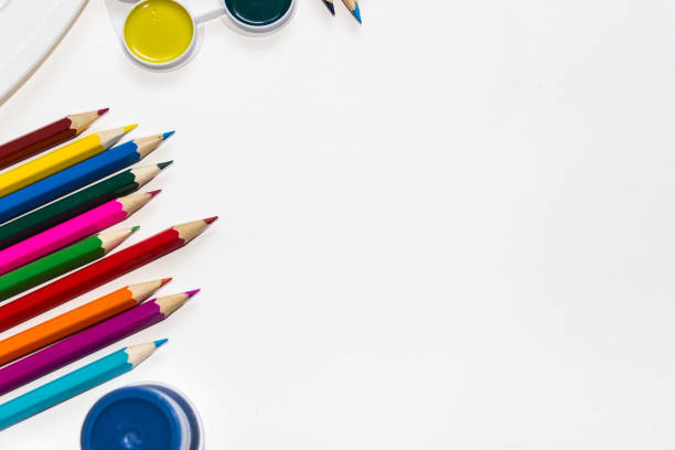 istock Color pencils and paints isolated on white background. Close up, top view, copy space. 1006697016