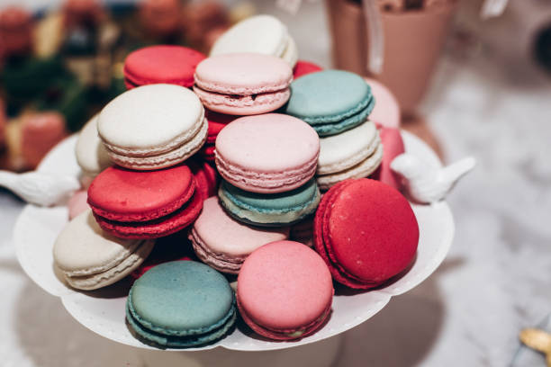 istock delicious macaroons. candy bar at luxury wedding reception. exclusive expensive catering. table with modern desserts. space for text. baby or bridal shower. holiday celebration 1006697404
