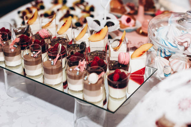istock delicious tiramisu. candy bar at luxury wedding reception. exclusive expensive catering. table with modern desserts, cupcakes, sweets with fruits. space for text. holiday celebration 1006697638