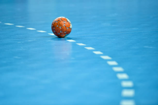 handball ball laying on the 9 meters dotted line handball ball laying on the 9 meters dotted line on the pitch handball stock pictures, royalty-free photos & images