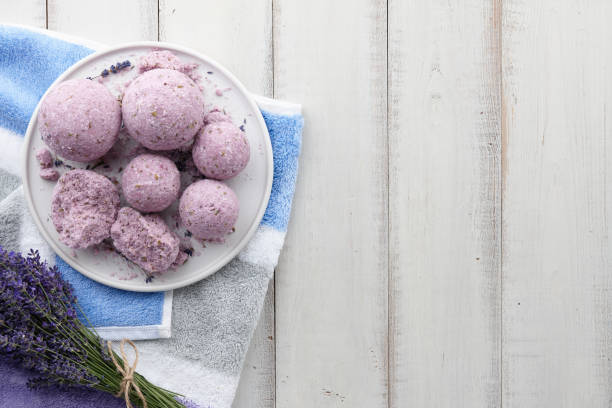 istock Handmade lavender bath bombs and flowers on white table 1006702044