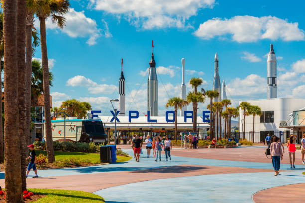 Entrance to Kennedy Space Center in Cape Canaveral Florida Cape Canaveral, FL, USA - April 1, 2015: Entrance to Kennedy Space Center Visitor Complex in Cape Canaveral, Florida, USA. People are walking out and towards the entrance gates. nasa kennedy space center photos stock pictures, royalty-free photos & images